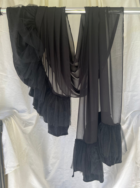 Black chiffon hijab with ruffles draped over a white background